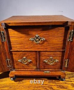 ATTRACTIVE LATE VICTORIAN OAK TABLE CABINET WITH DECORATIVE BRASS MOUNTS c. 1895