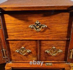 ATTRACTIVE LATE VICTORIAN OAK TABLE CABINET WITH DECORATIVE BRASS MOUNTS c. 1895