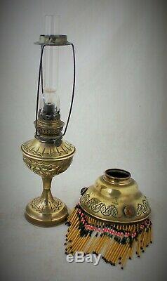French antique oil lamp with jeweled shade and beaded trim late 1800s