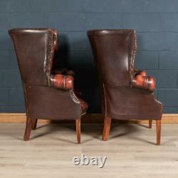 LATE 20th CENTURY PAIR OF ENGLISH LEATHER BARREL BACK ARMCHAIRS