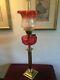 Late 19th century oil lamp with Cranberry Reservoir on a Corinthian brass column