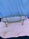 Late 20th Century Hollywood Regency Oval Glass and Brass Coffee Table