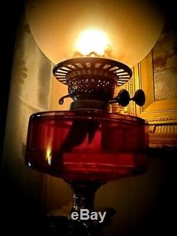 Late Victorian cranberry glass oil lamp and shade