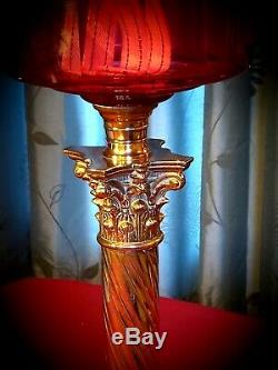 Late Victorian cranberry glass oil lamp and shade