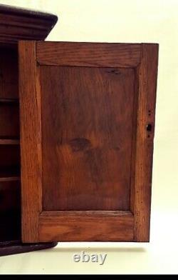 Late Victorian oak wall hanging or freestanding cupboard with single panel door
