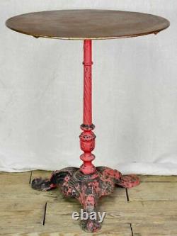 Late nineteenth century French bistro table with red cast iron base
